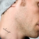Overview of men's tattoo on the neck in the form of inscriptions
