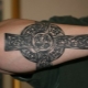 Men's tattoo in the form of a cross on the arm
